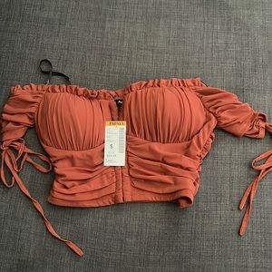 Papaya brand, sized S. Burgundy-maybe a light orange color